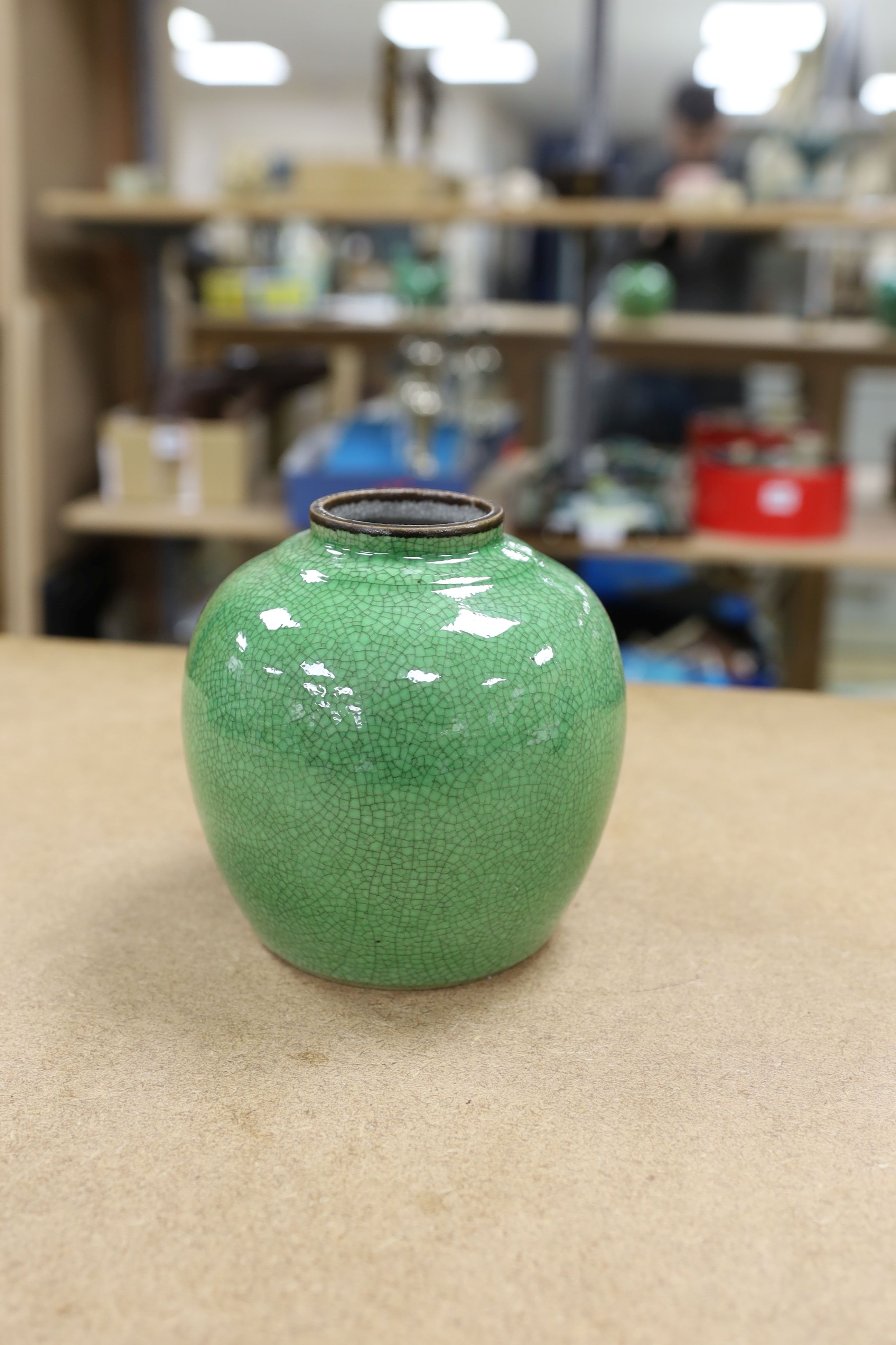 A 19th century Chinese green glazed model of a lion-dog, and two green crackle glaze jars, tallest 16cm